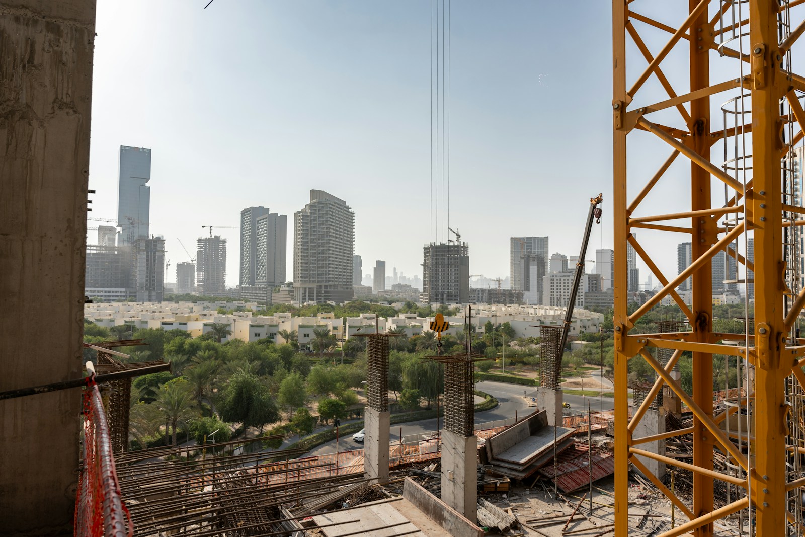 Construction and city skyline viewed from an office workspace, representing operations planning and ERP visibility in Oman